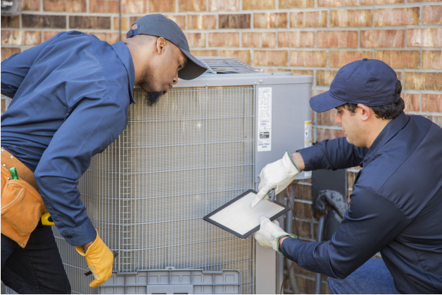 two technicians in front of AC unit | Pro Comfort Heating & Cooling